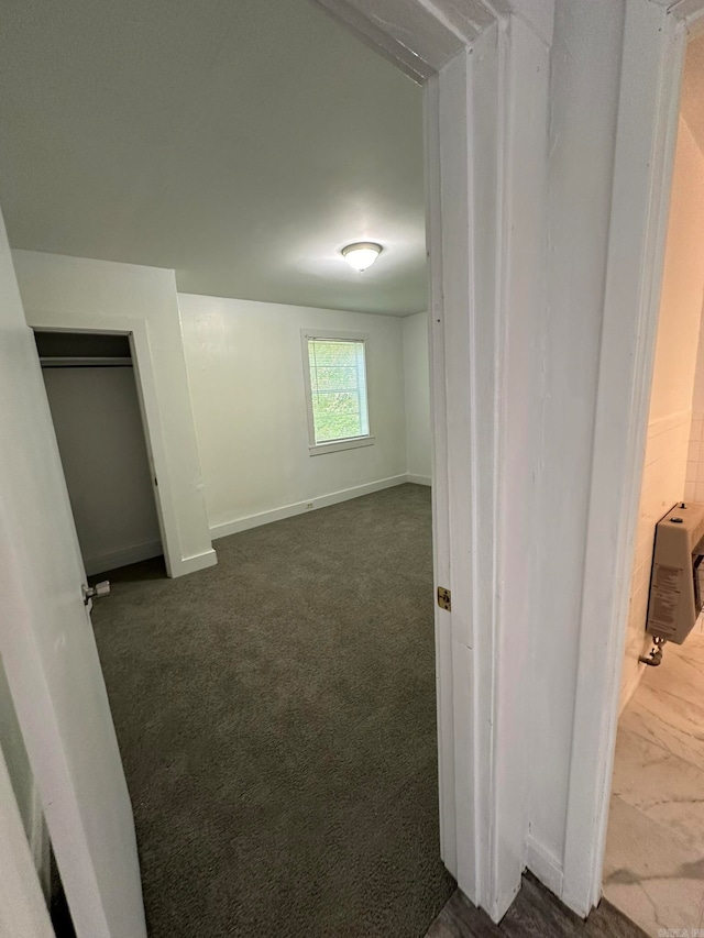 interior space with dark colored carpet