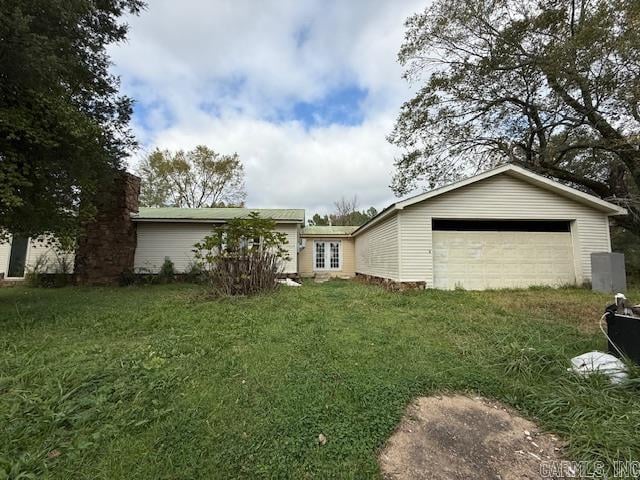 exterior space featuring a garage and a yard