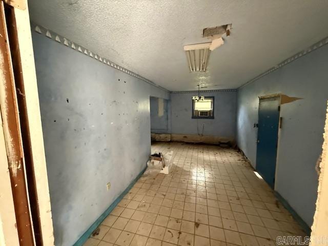 spare room with a textured ceiling