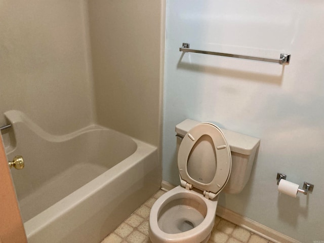 bathroom featuring a tub to relax in and toilet