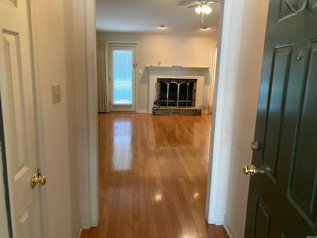 hallway featuring hardwood / wood-style floors and a textured ceiling