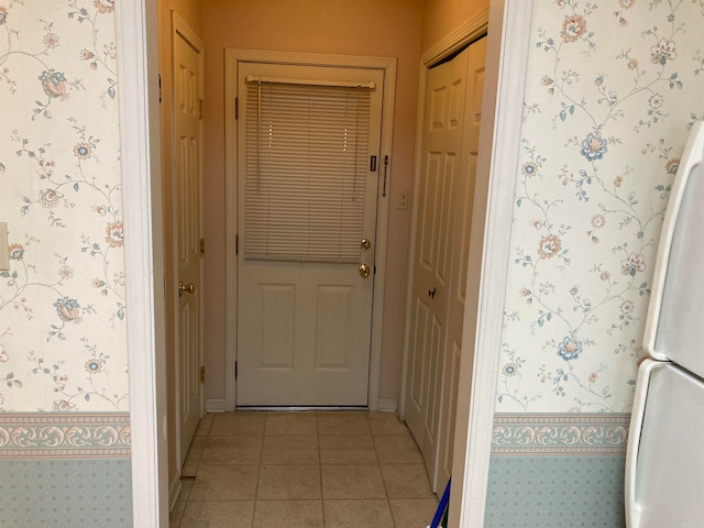 doorway with light tile patterned floors