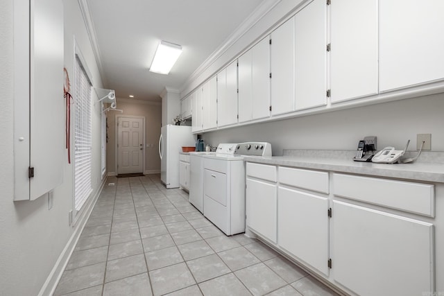 laundry room featuring ornamental molding, separate washer and dryer, cabinets, and light tile patterned flooring