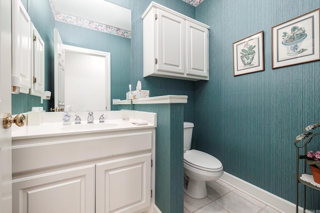 bathroom featuring toilet, vanity, and tile patterned flooring