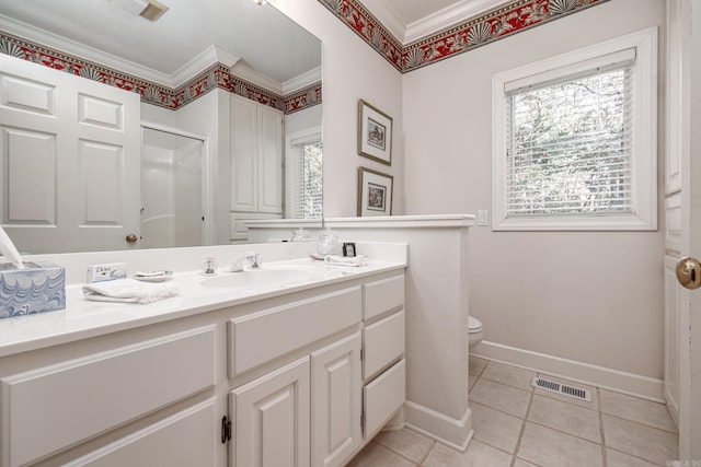 bathroom with tile patterned floors, crown molding, vanity, toilet, and a shower with shower door