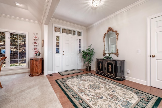 entryway featuring ornamental molding, hardwood / wood-style floors, and beam ceiling