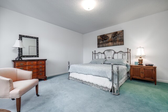 carpeted bedroom with a textured ceiling