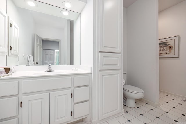 bathroom with tile patterned flooring, vanity, and toilet