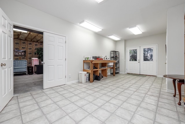 home office with french doors and light tile patterned flooring