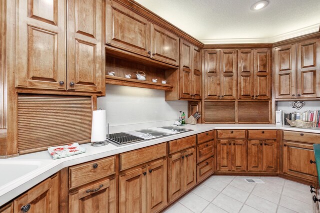 kitchen with a textured ceiling and light tile patterned floors