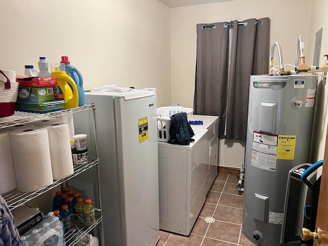 laundry area with water heater, laundry area, tile patterned flooring, and washing machine and dryer