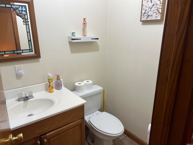 bathroom featuring tile patterned floors, toilet, and vanity