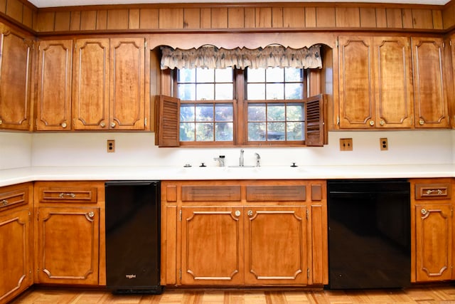 kitchen with light parquet flooring and black dishwasher