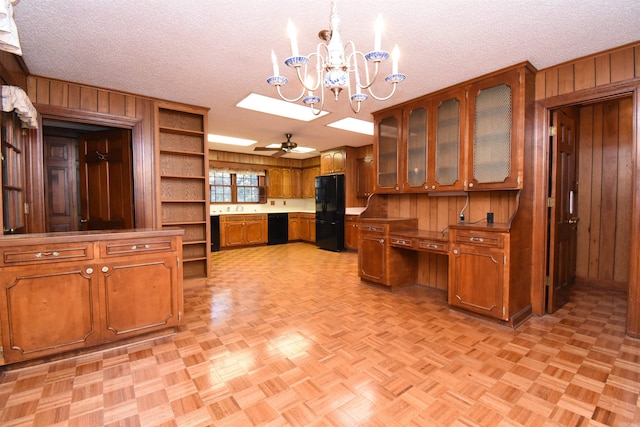 kitchen featuring ceiling fan with notable chandelier, a textured ceiling, black appliances, and decorative light fixtures