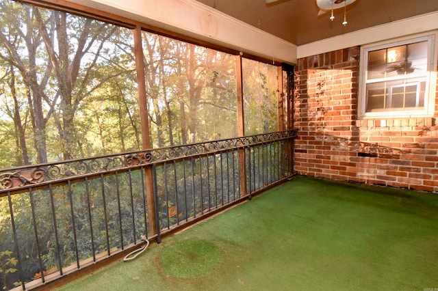 unfurnished sunroom featuring ceiling fan