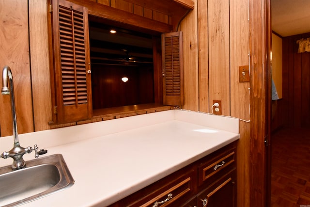 bathroom featuring parquet floors, vanity, and wooden walls