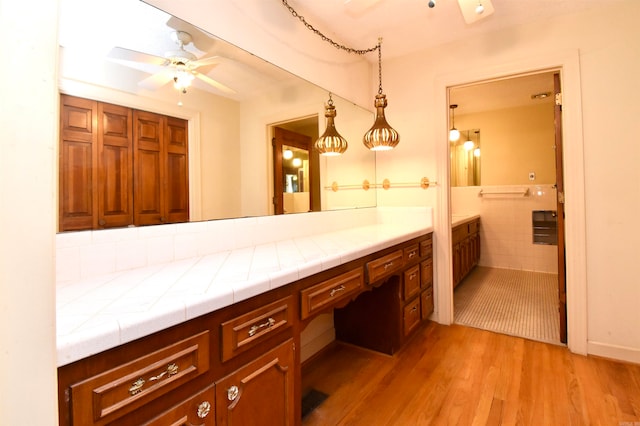 bathroom with hardwood / wood-style floors and ceiling fan