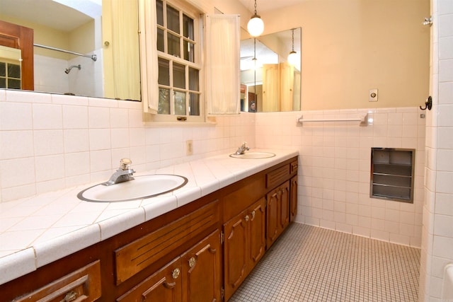 bathroom with vanity, tile walls, and tile patterned floors