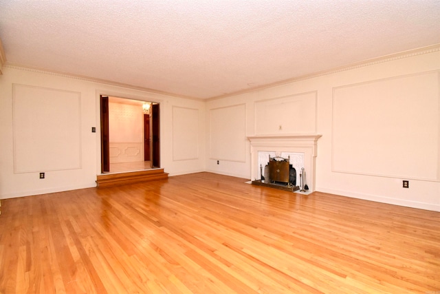 unfurnished living room with a textured ceiling and light hardwood / wood-style flooring