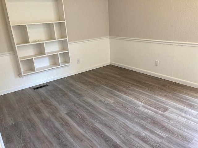 spare room with dark hardwood / wood-style flooring