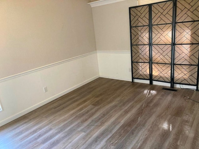 unfurnished room featuring dark wood-type flooring