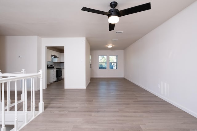 interior space with light hardwood / wood-style flooring and ceiling fan