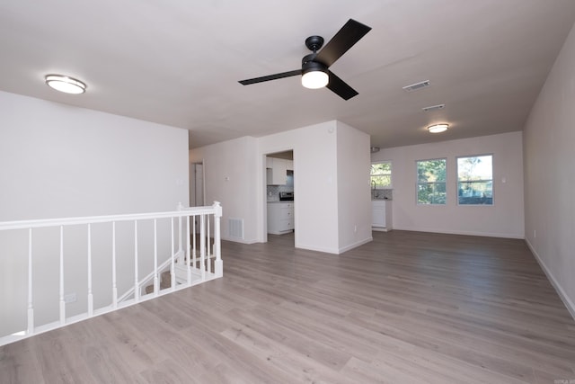 empty room with hardwood / wood-style flooring and ceiling fan