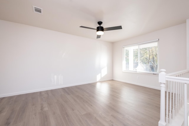 unfurnished room featuring hardwood / wood-style flooring and ceiling fan