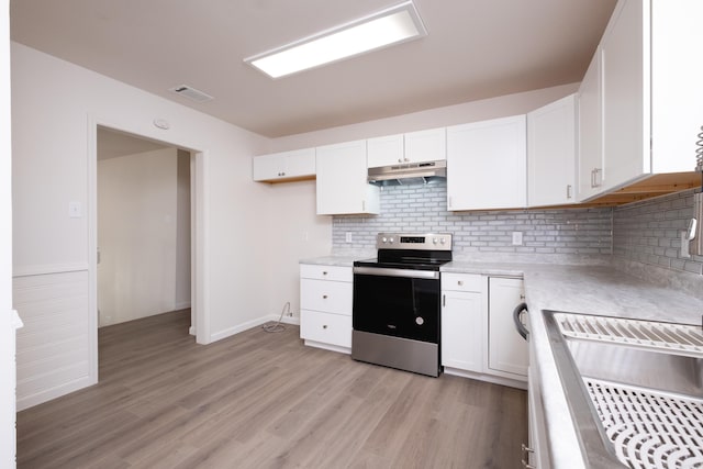 kitchen with white cabinetry, light hardwood / wood-style flooring, tasteful backsplash, and electric range