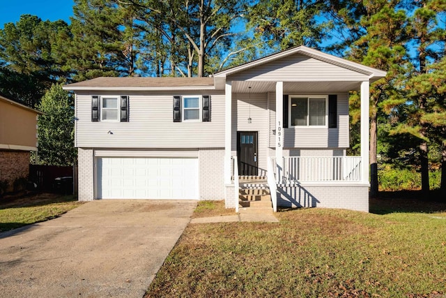 bi-level home featuring a garage, a front yard, and a porch