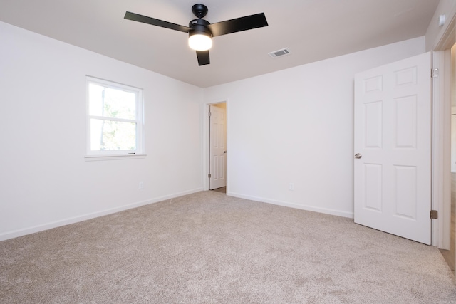 unfurnished room featuring ceiling fan and light colored carpet