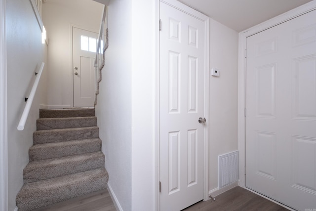 stairs featuring hardwood / wood-style flooring