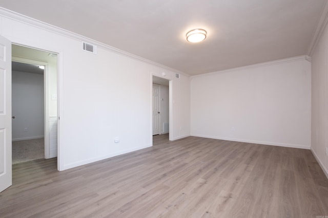 unfurnished room with light wood-type flooring and crown molding