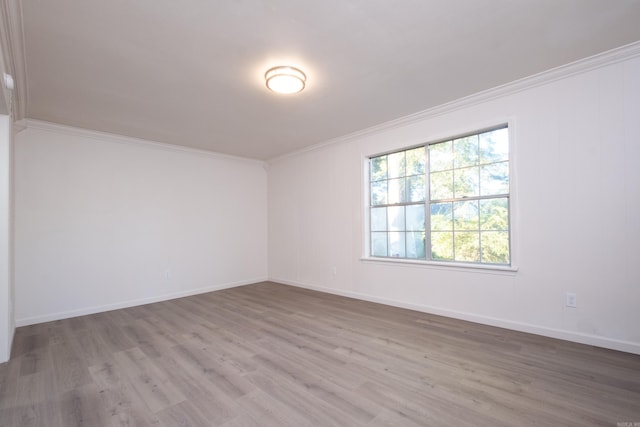 unfurnished room with hardwood / wood-style flooring and ornamental molding