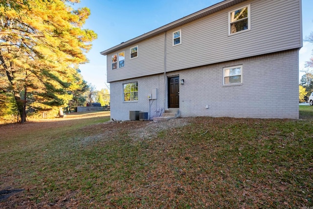 rear view of property featuring a yard