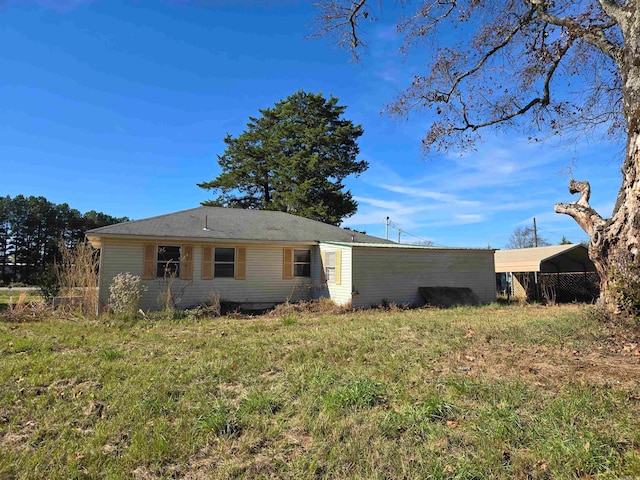 rear view of property with a yard