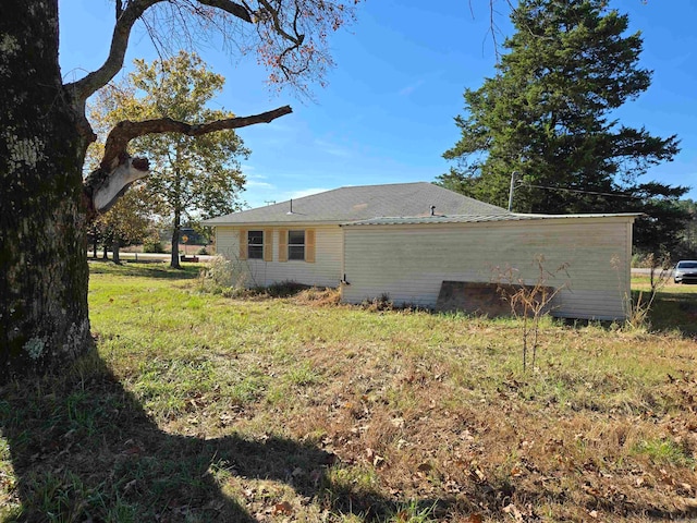 view of side of home featuring a yard