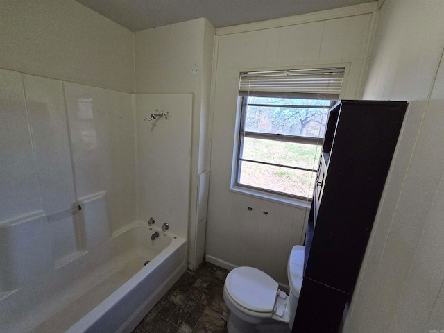 bathroom featuring washtub / shower combination and toilet