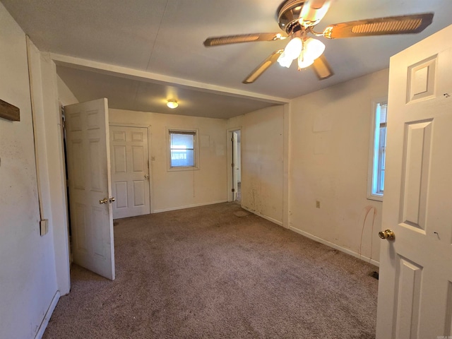 carpeted empty room featuring ceiling fan