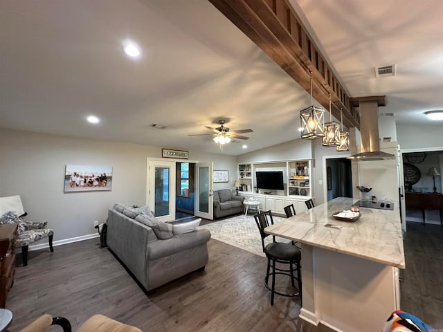 living room featuring dark wood-type flooring, ceiling fan, and vaulted ceiling