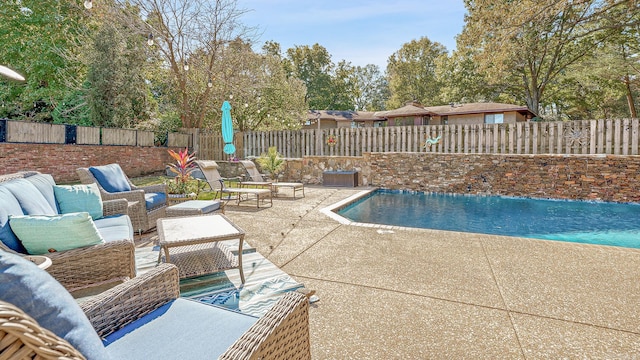 view of swimming pool with an outdoor living space and a patio area