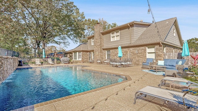 view of pool featuring pool water feature and a patio