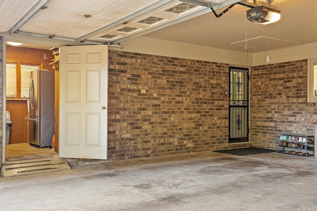 garage featuring a garage door opener and stainless steel refrigerator