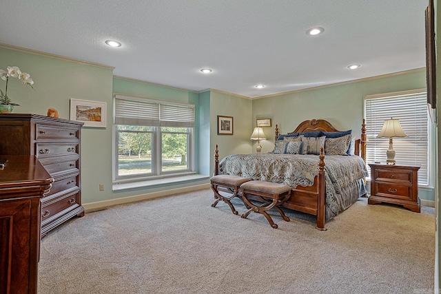 bedroom with a textured ceiling, light colored carpet, and ornamental molding