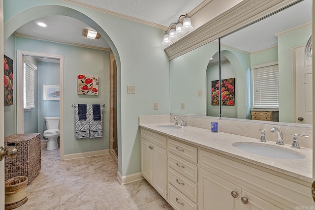 bathroom with toilet, a textured ceiling, vanity, crown molding, and a shower with shower door