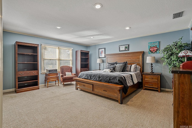 bedroom featuring a textured ceiling, light colored carpet, and crown molding