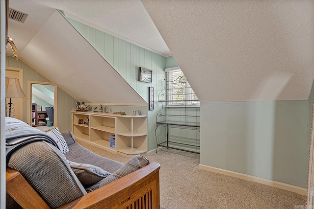 interior space featuring light carpet, a textured ceiling, and vaulted ceiling