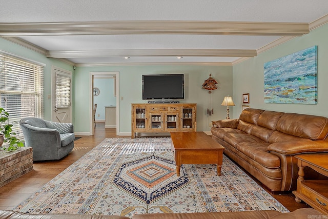 living room with beam ceiling, crown molding, and light hardwood / wood-style flooring