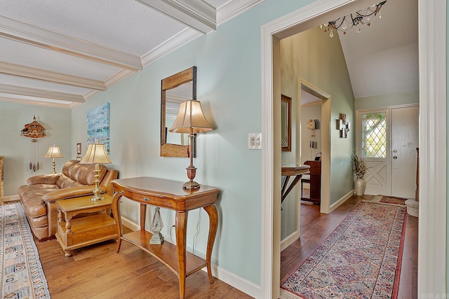 interior space with beam ceiling, hardwood / wood-style flooring, and crown molding