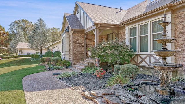 view of side of home with a lawn